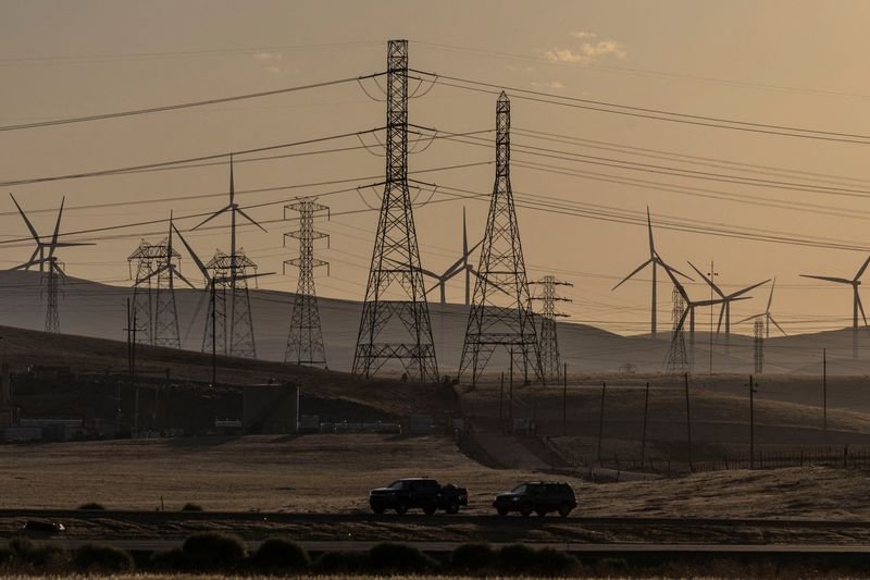 © Reuters. FILE PHOTO: A view of windmills and power lines, as California